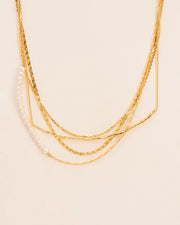 Layered necklace with branch element, chains and pearls string