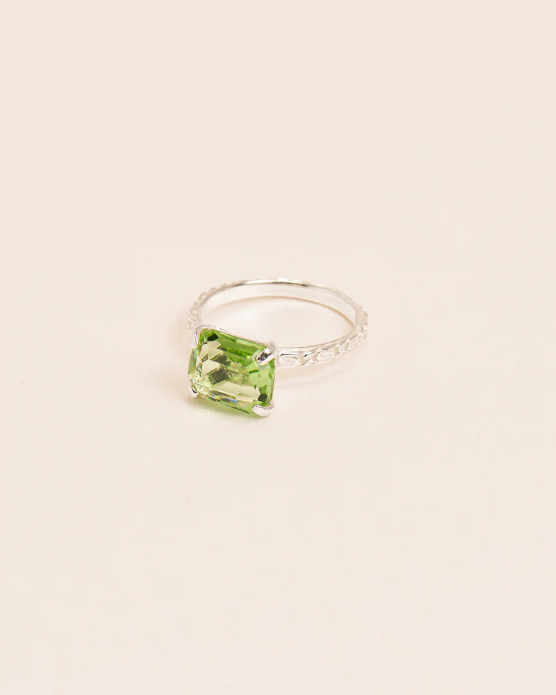Ring with 'Chapters' texture and peridot crystal